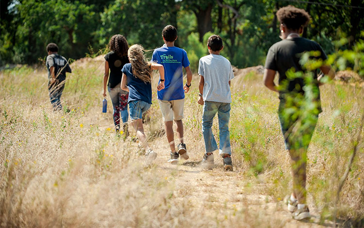 children outside on walking trail 